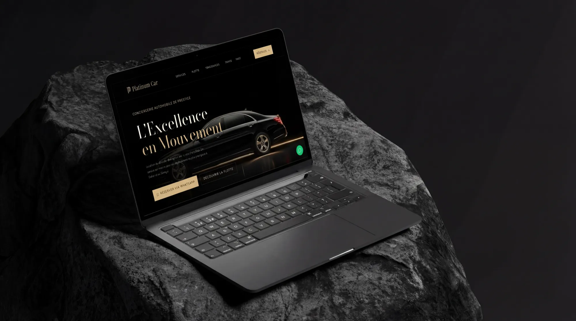 Platinum Car rental website displayed on a laptop resting on dark stone